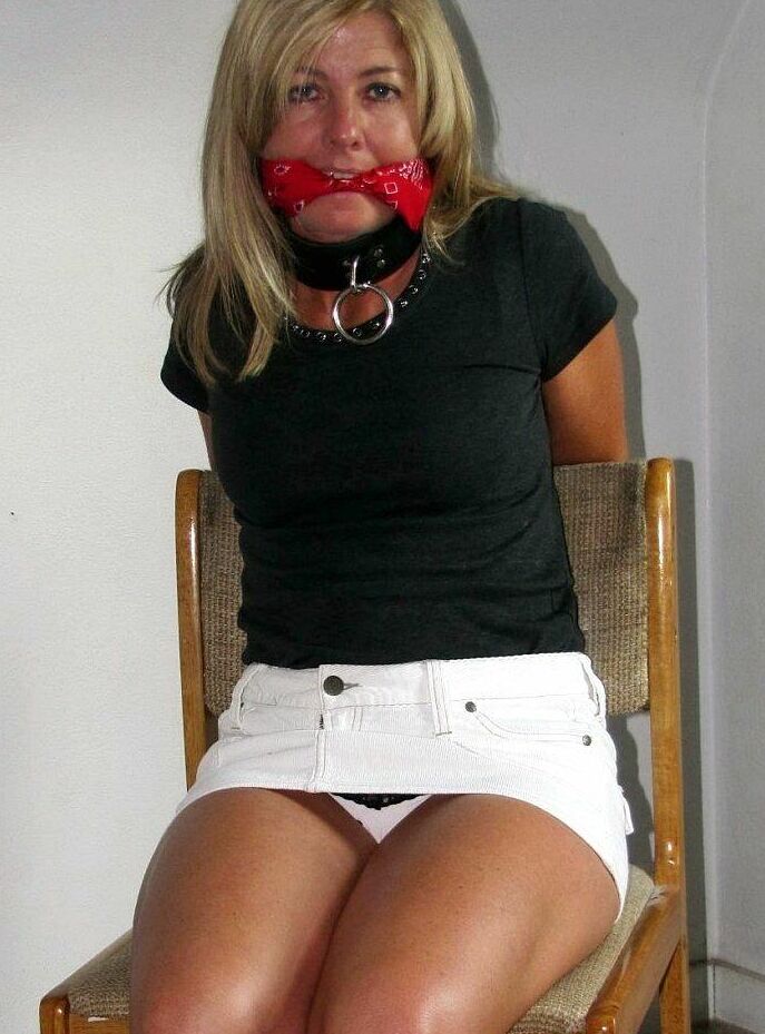 14P Blonde woman is gagged while her ankles and wrists are bound with rope