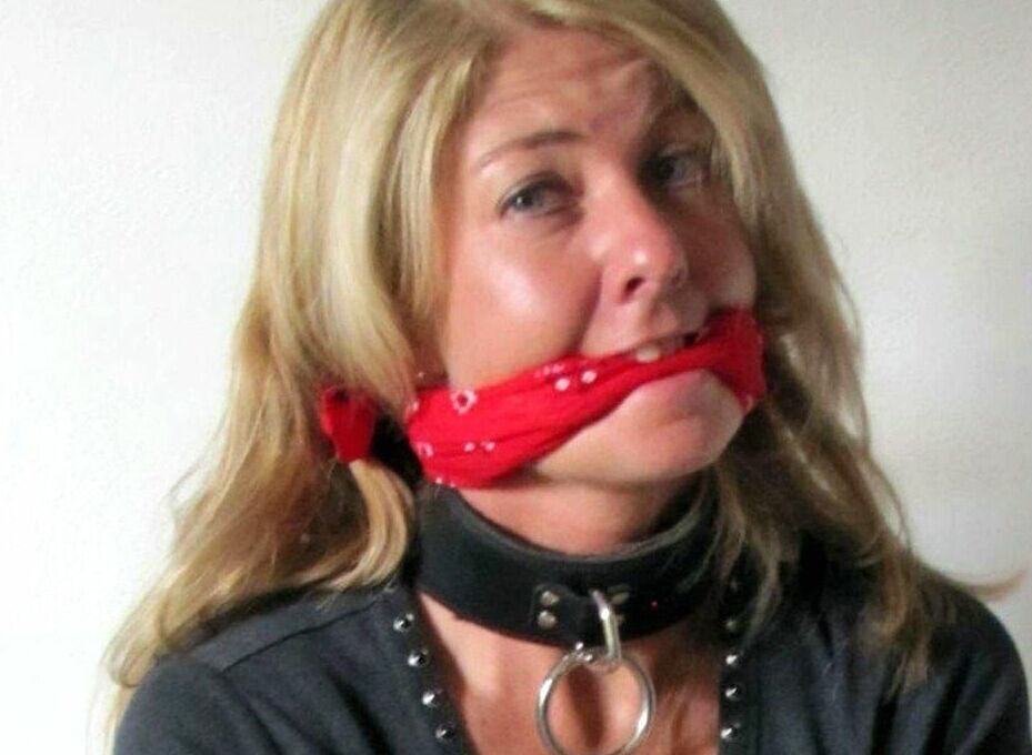 14P Blonde woman is gagged while her ankles and wrists are bound with rope