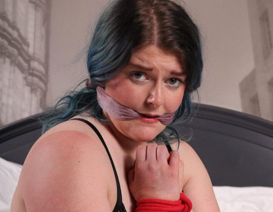 16P Brunette chick in black hosiery and lingerie struggles against bindings on bed