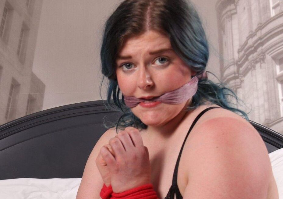 16P Brunette chick in black hosiery and lingerie struggles against bindings on bed