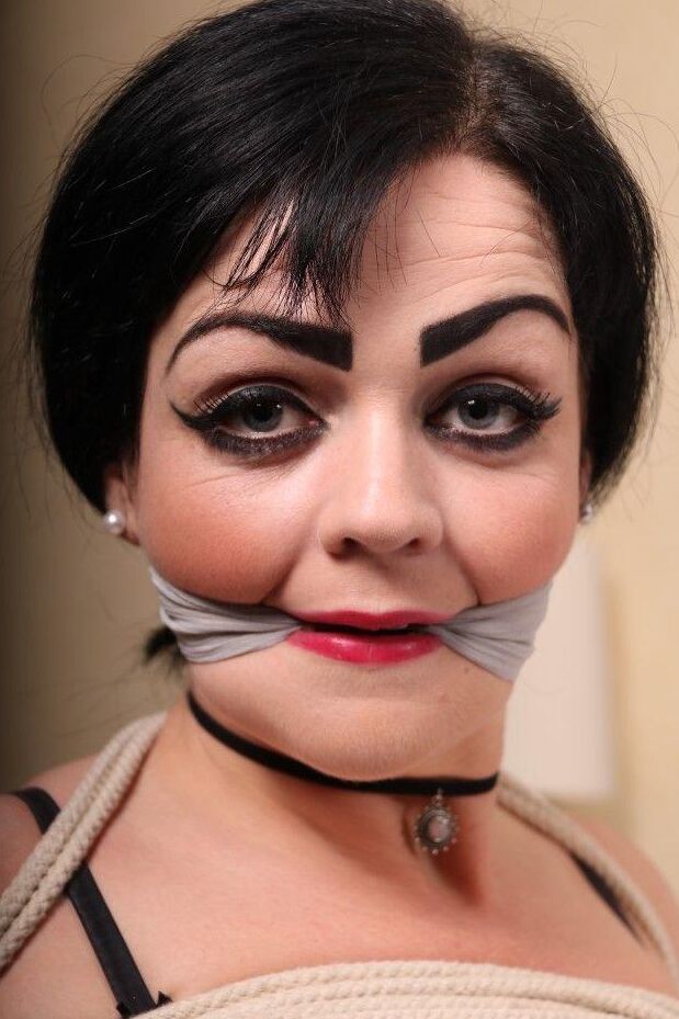 16P Dark haired girl is cleave gagged and rope bound in black lingerie and hosiery