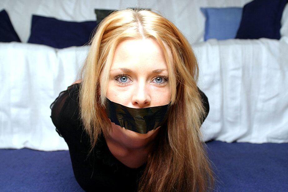 12P Natural blonde with blue eyes is left duct taped and hog tied in clothing