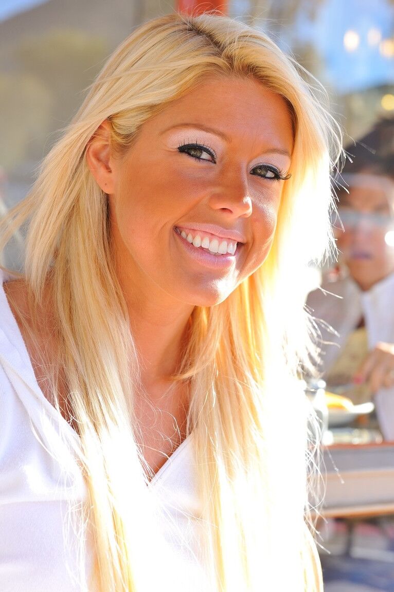 12P Blonde amateur wears nothing more than a smile while showcasing her bald pussy