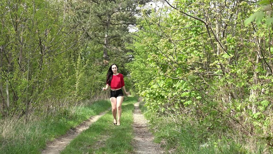 15P Dark haired girl Corin takes a piss while out for a walk on a country lane
