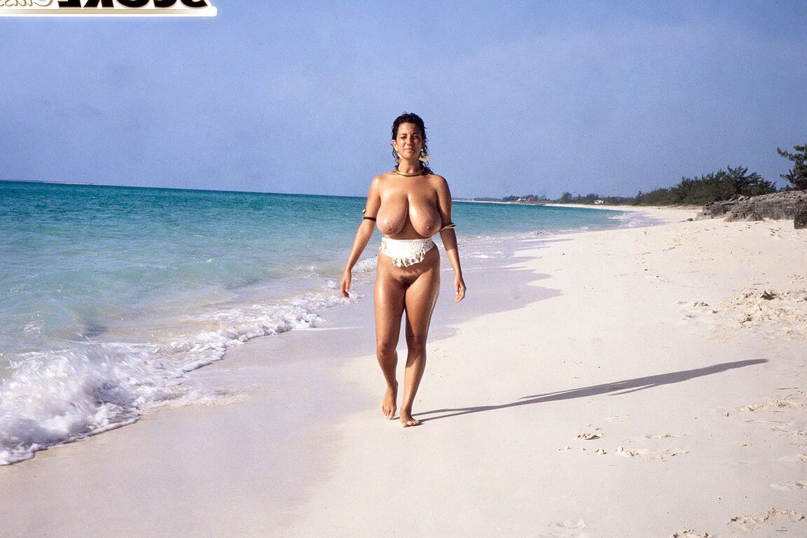 16P Busty MILF Devon Daniels gets her massive melons covered in sand at the beach