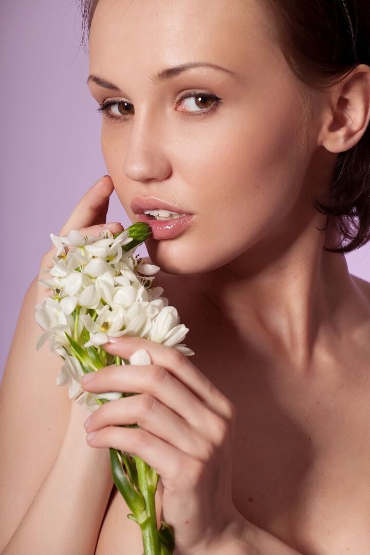 16P Petite model Scala D holds a flower while striking tempting nude poses