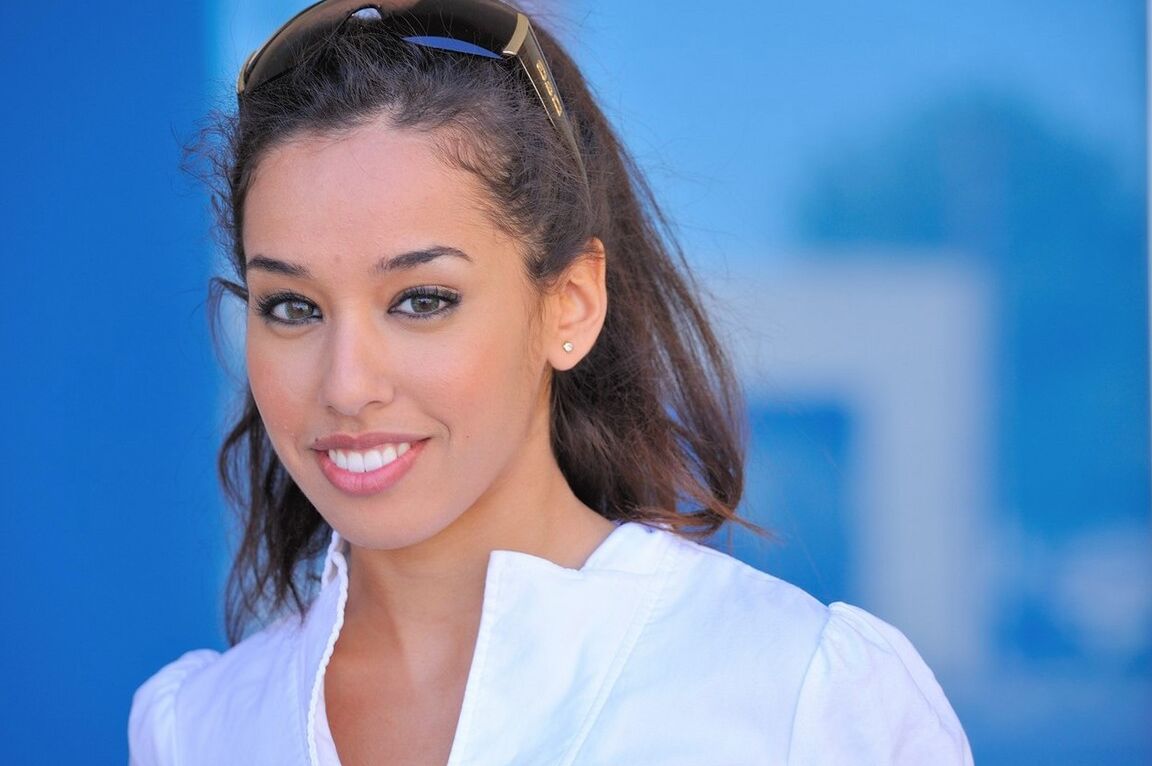 16P Ten girl with a nice smile goes topless on a sidewalk before baring her butt