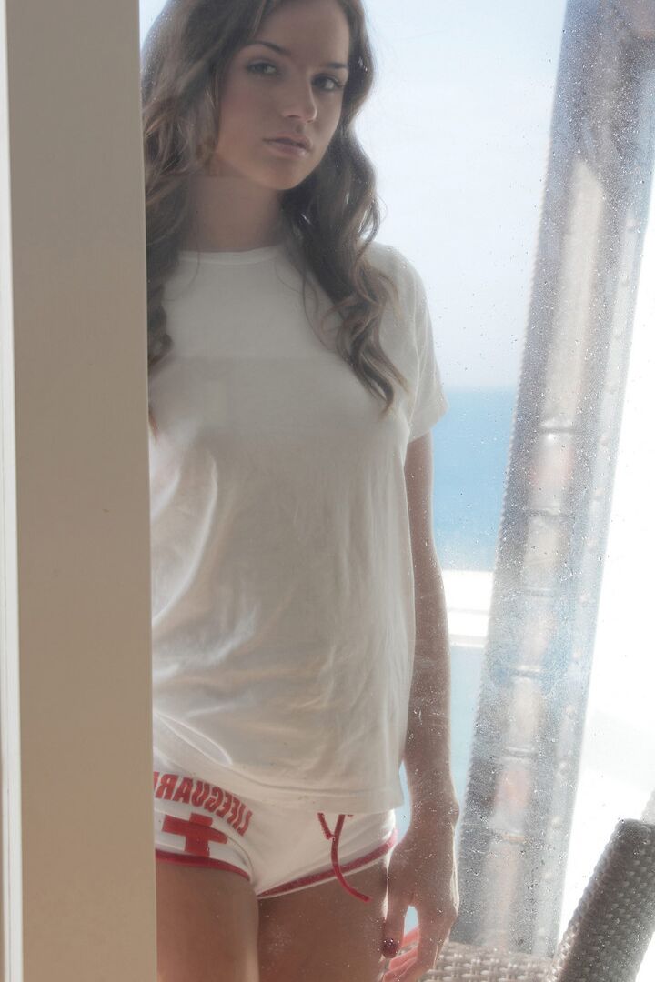 16P Solo model slides shorts over her nice ass on beach side balcony