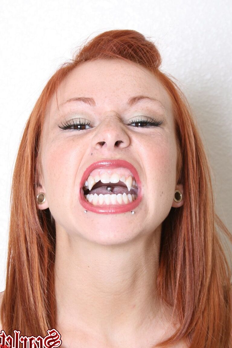 15P Natural redhead Scarlett wears vampire fangs and bodystocking in solo action