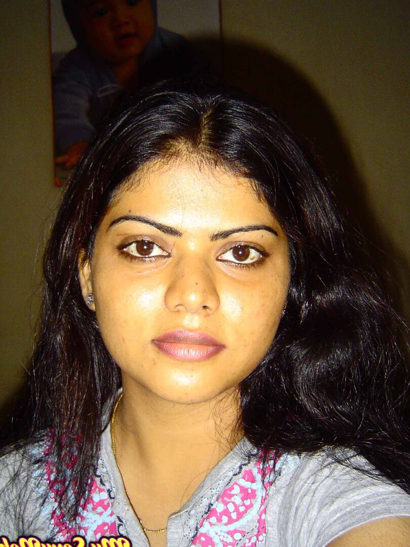 15P Indian woman Neha takes self shots while she holds her face firm