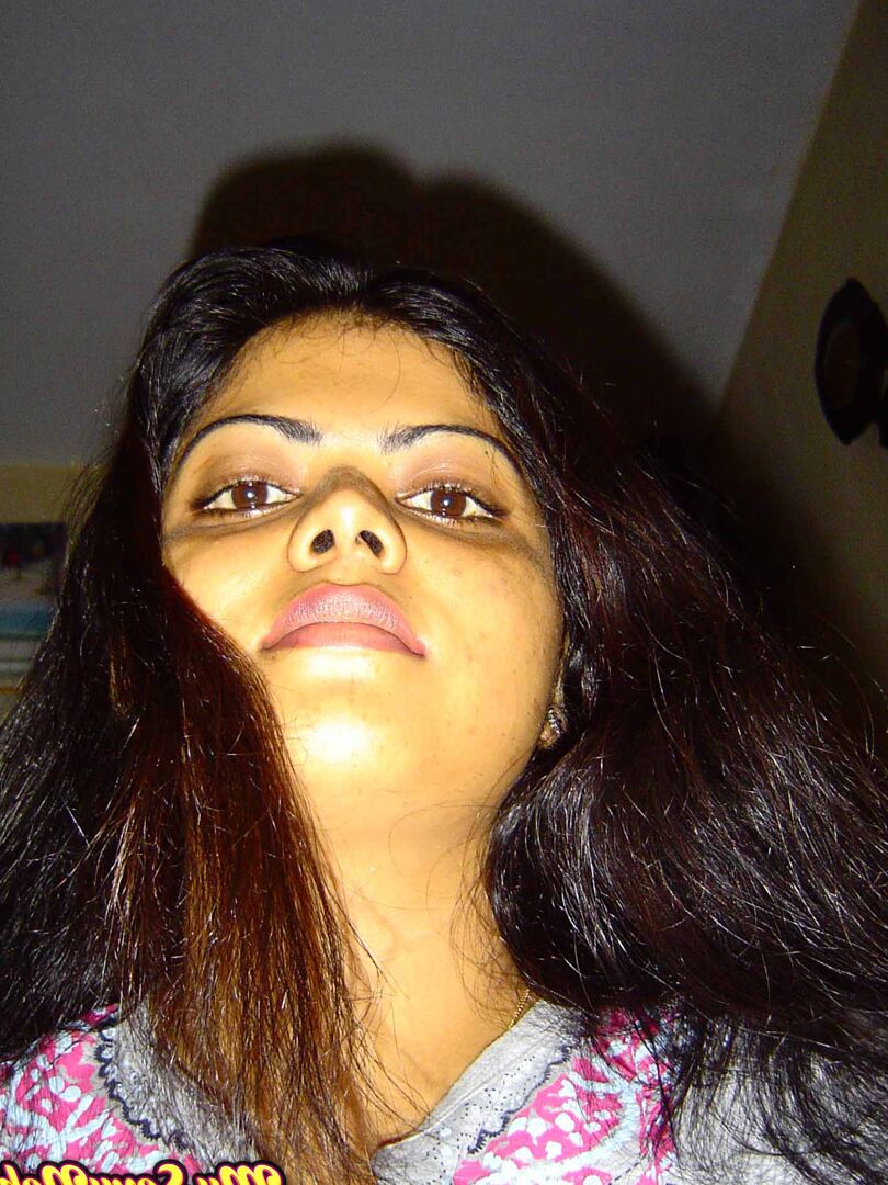 15P Indian woman Neha takes self shots while she holds her face firm