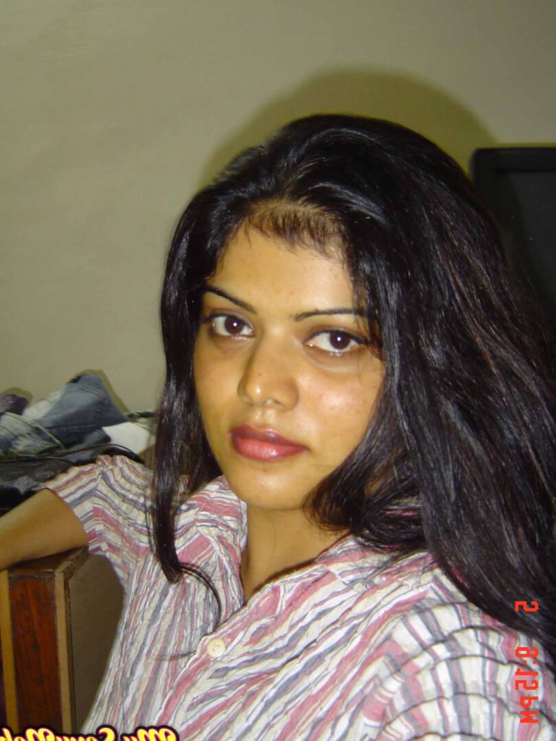 15P Indian woman Neha takes self shots while she holds her face firm