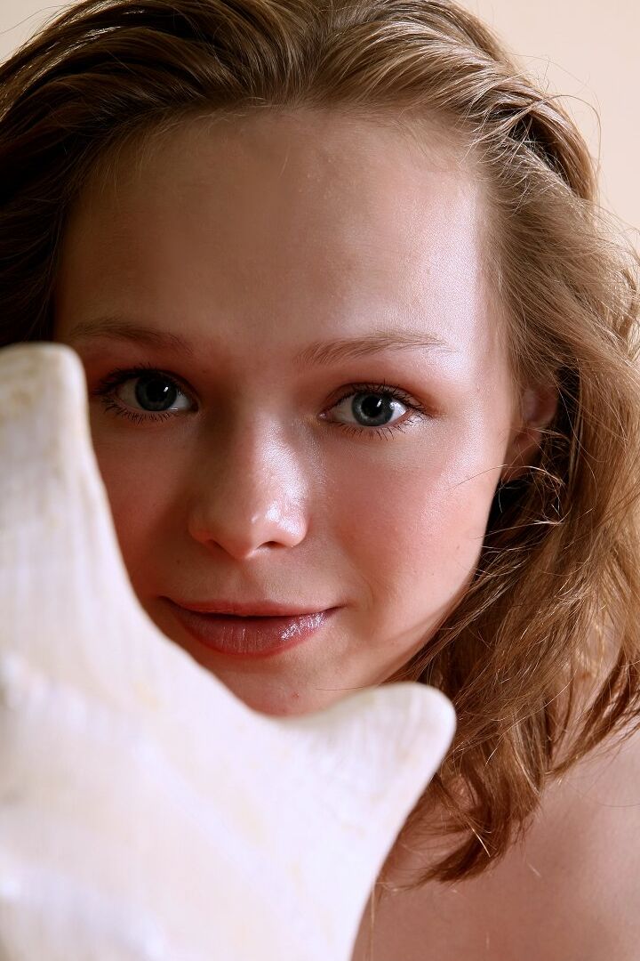 16P Caucasian girl stretches out on a sofa ensemble while totally naked