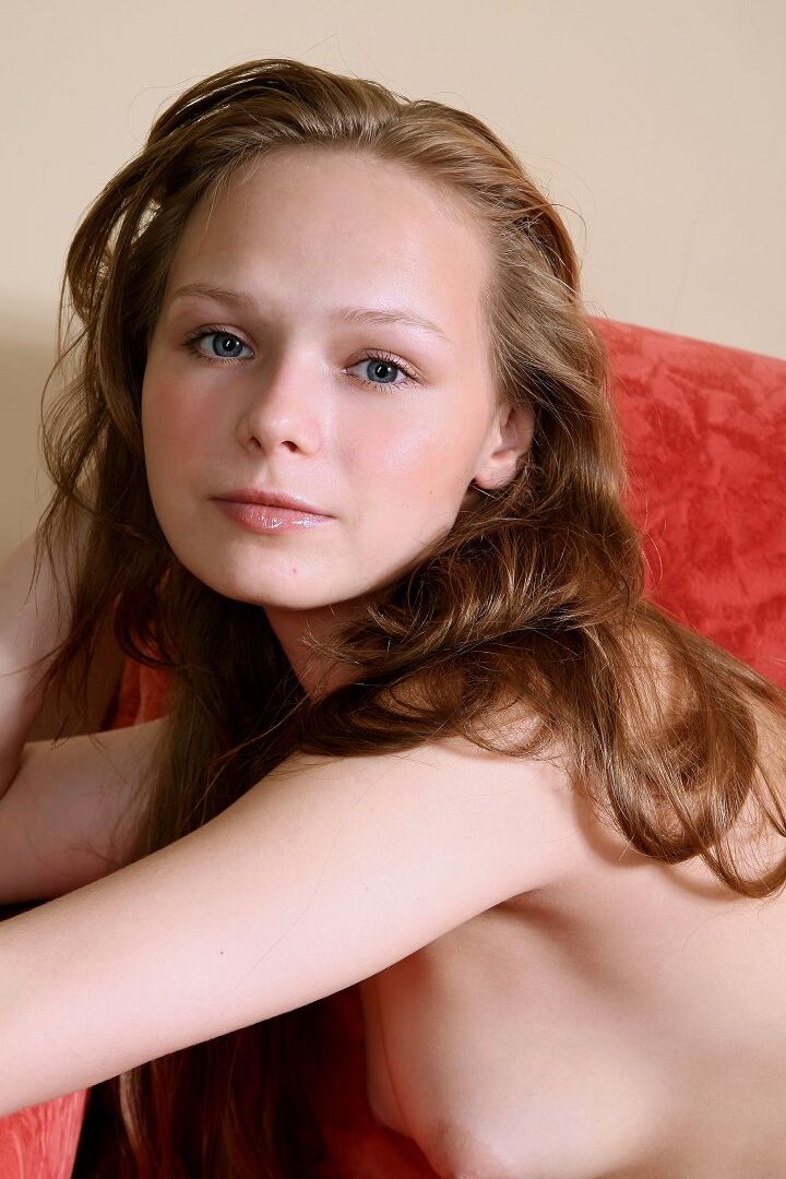 16P Caucasian girl stretches out on a sofa ensemble while totally naked