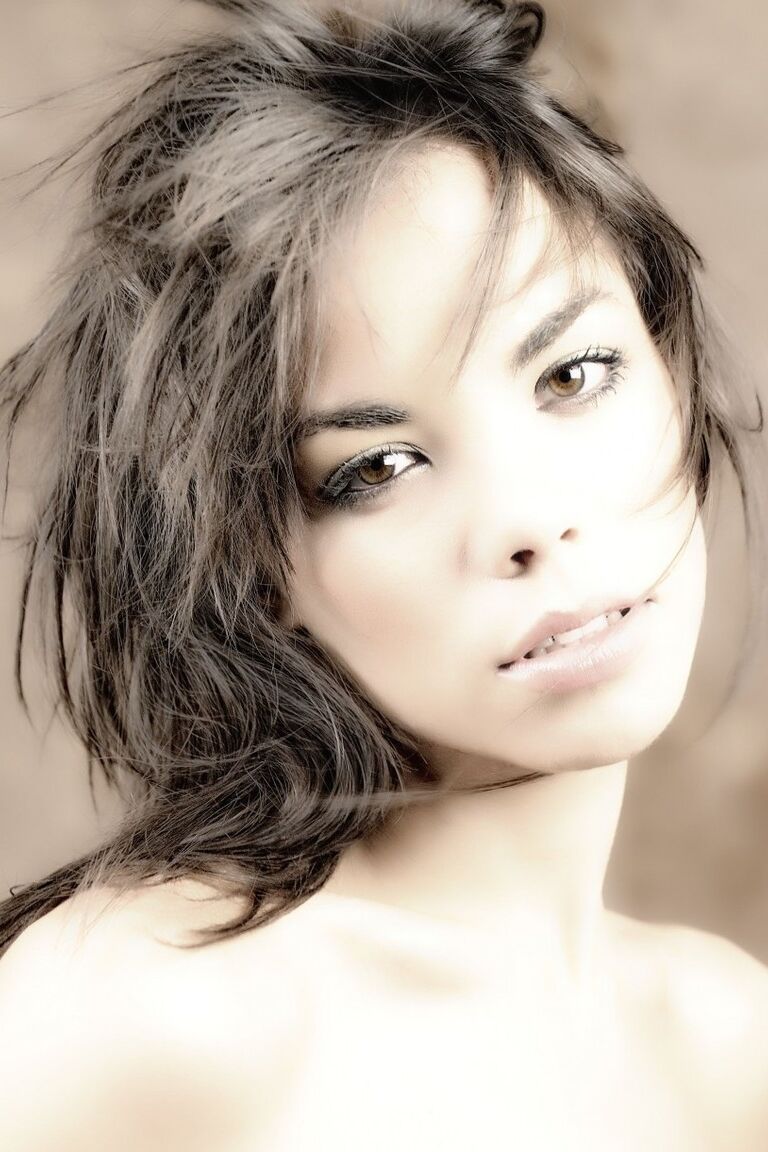 16P Une belle fille avec un joli visage enfile un chapeau d'hiver lors d'une séance glamour