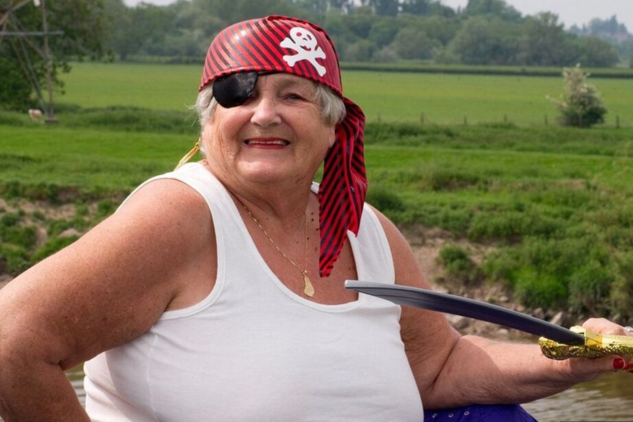 20P Fat British granny exposes herself on a bridge while sporting pirate attire