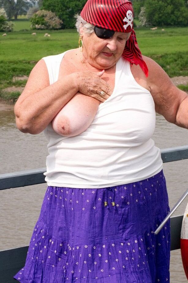 20P Fat British granny exposes herself on a bridge while sporting pirate attire