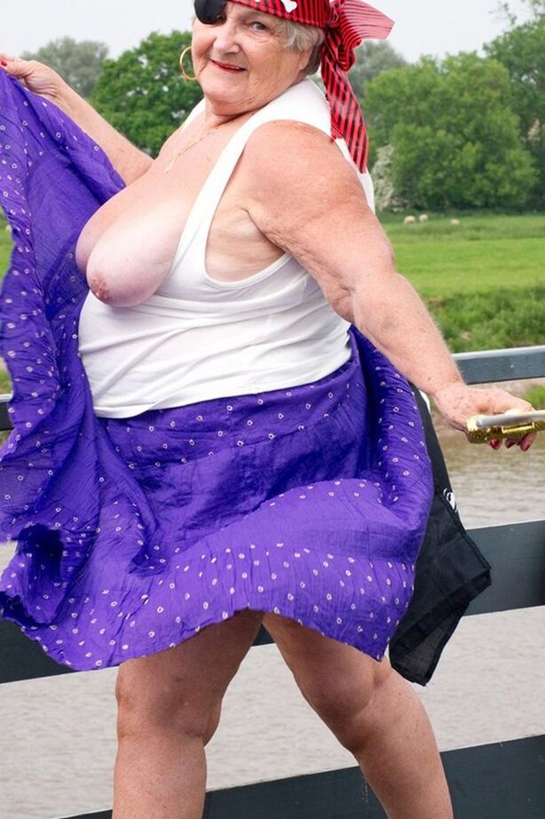 20P Fat British granny exposes herself on a bridge while sporting pirate attire
