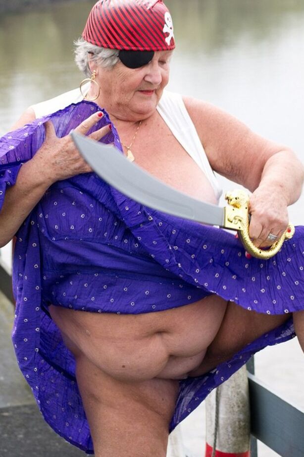20P Fat British granny exposes herself on a bridge while sporting pirate attire