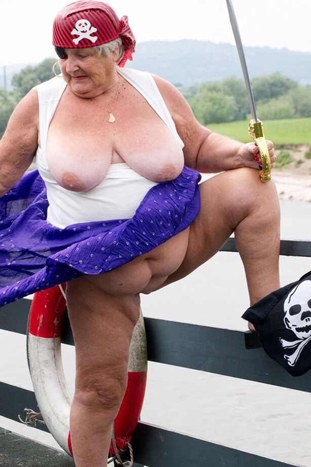 20P Fat British granny exposes herself on a bridge while sporting pirate attire