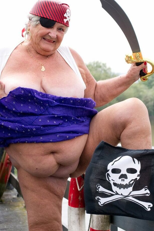 20P Fat British granny exposes herself on a bridge while sporting pirate attire