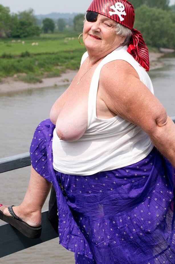 20P Fat British granny exposes herself on a bridge while sporting pirate attire