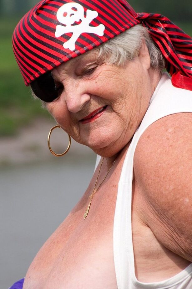 20P Fat British granny exposes herself on a bridge while sporting pirate attire