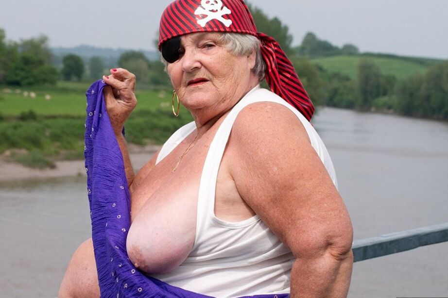 20P Fat British granny exposes herself on a bridge while sporting pirate attire