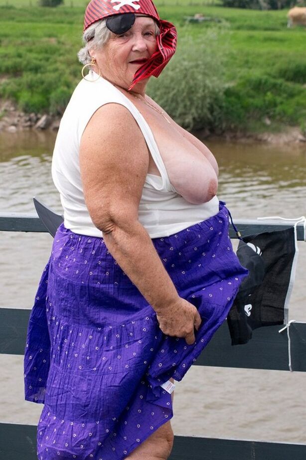 20P Fat British granny exposes herself on a bridge while sporting pirate attire