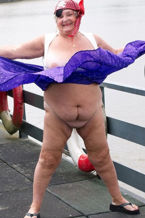 20P Fat British granny exposes herself on a bridge while sporting pirate attire