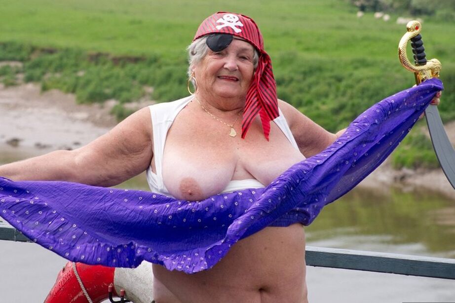 20P Fat British granny exposes herself on a bridge while sporting pirate attire