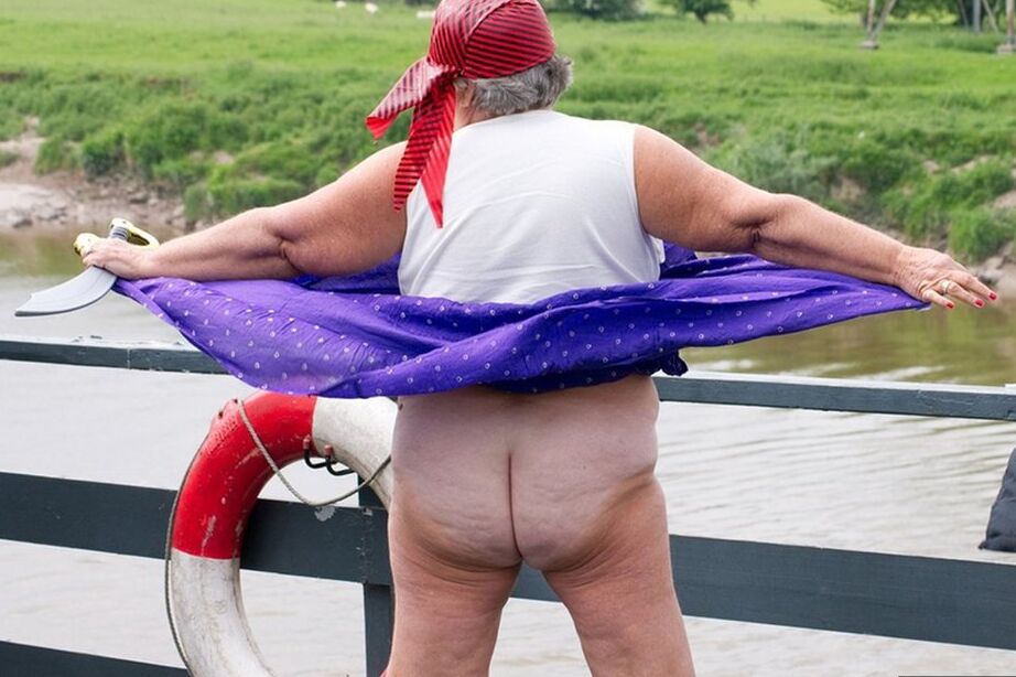 20P Fat British granny exposes herself on a bridge while sporting pirate attire