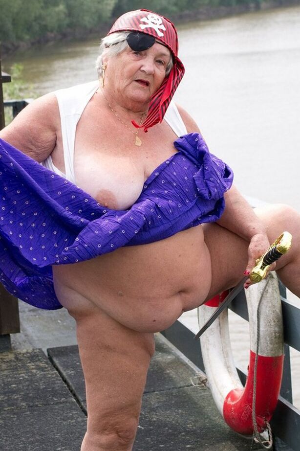 20P Fat British granny exposes herself on a bridge while sporting pirate attire