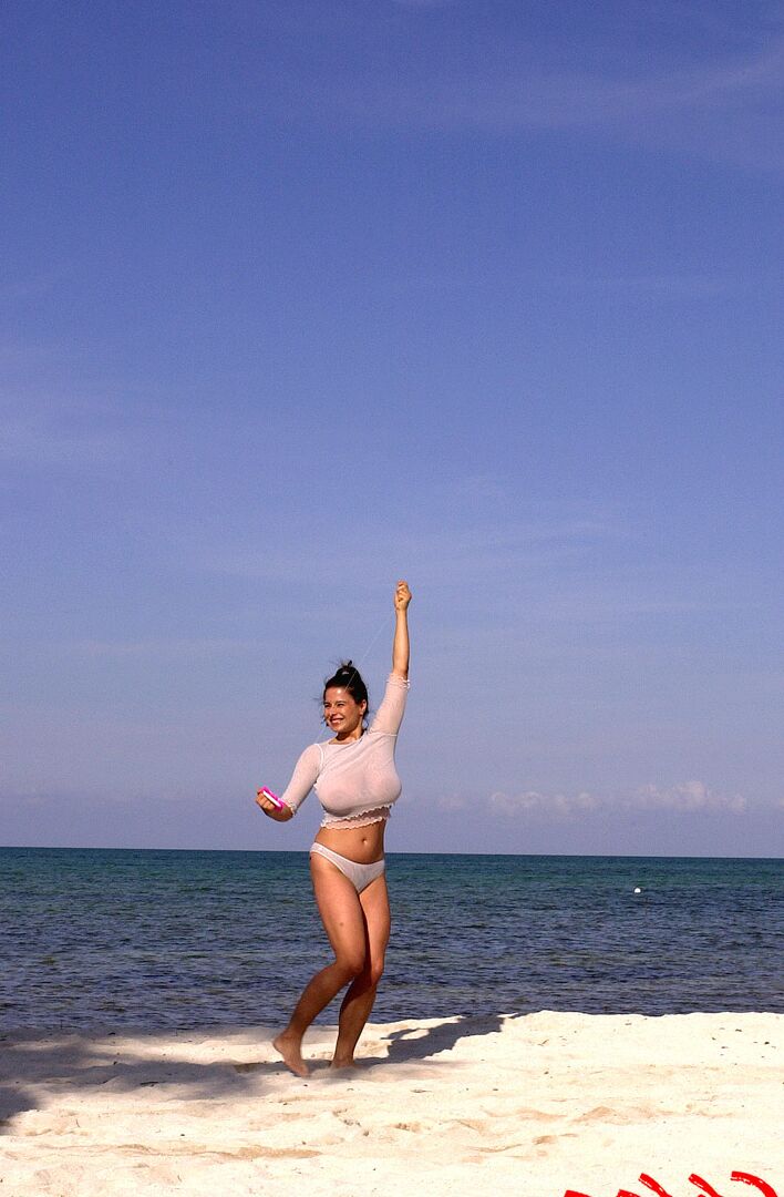 16P Super busty Chloe Vevrier letting her massive big tits hang loose at the beach