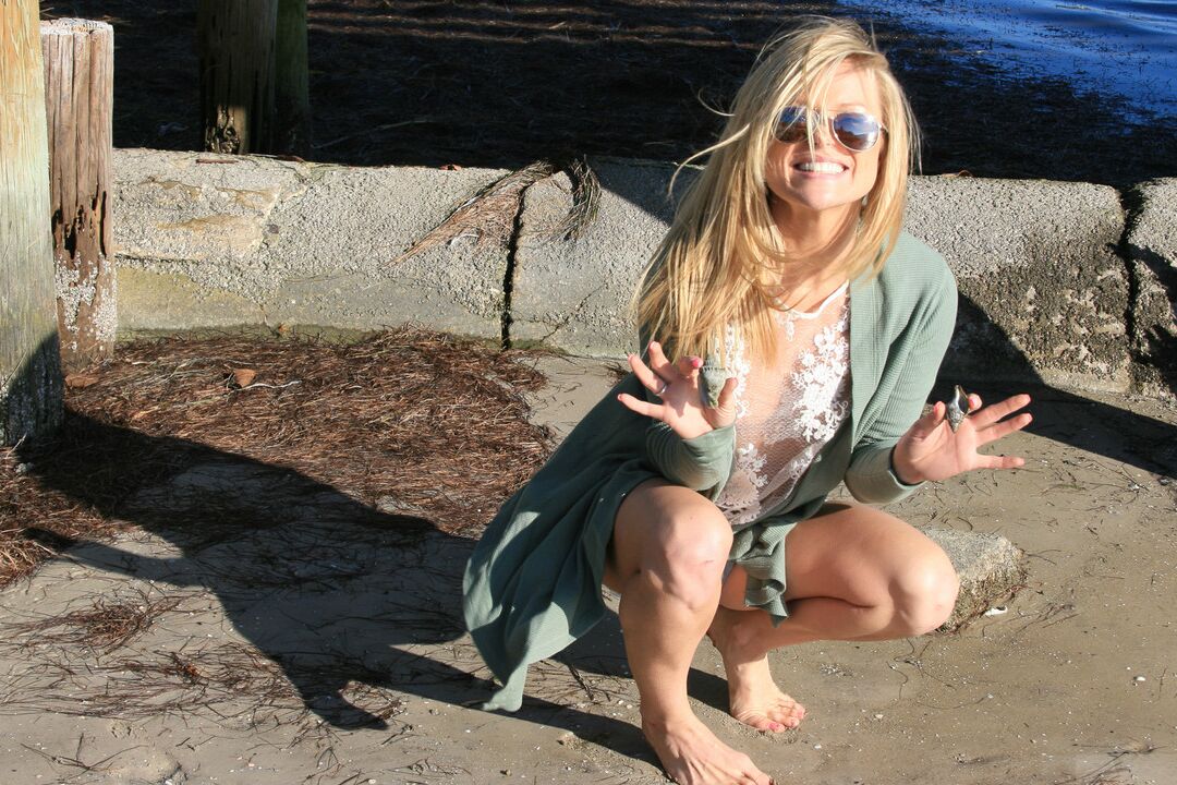 15P Blonde amateur Meet Madden prances about under a dock in a thong