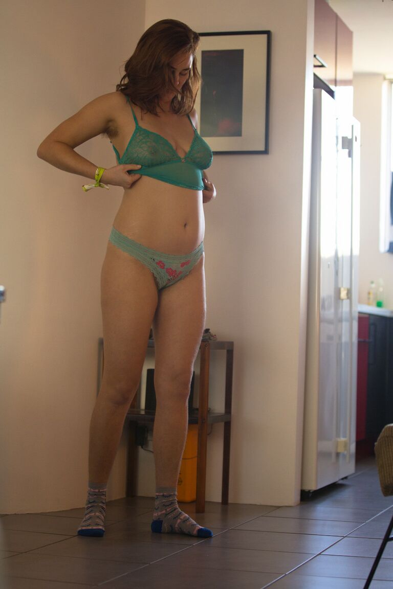 17P White female in striped socks pulls on a thong as she gets dressed