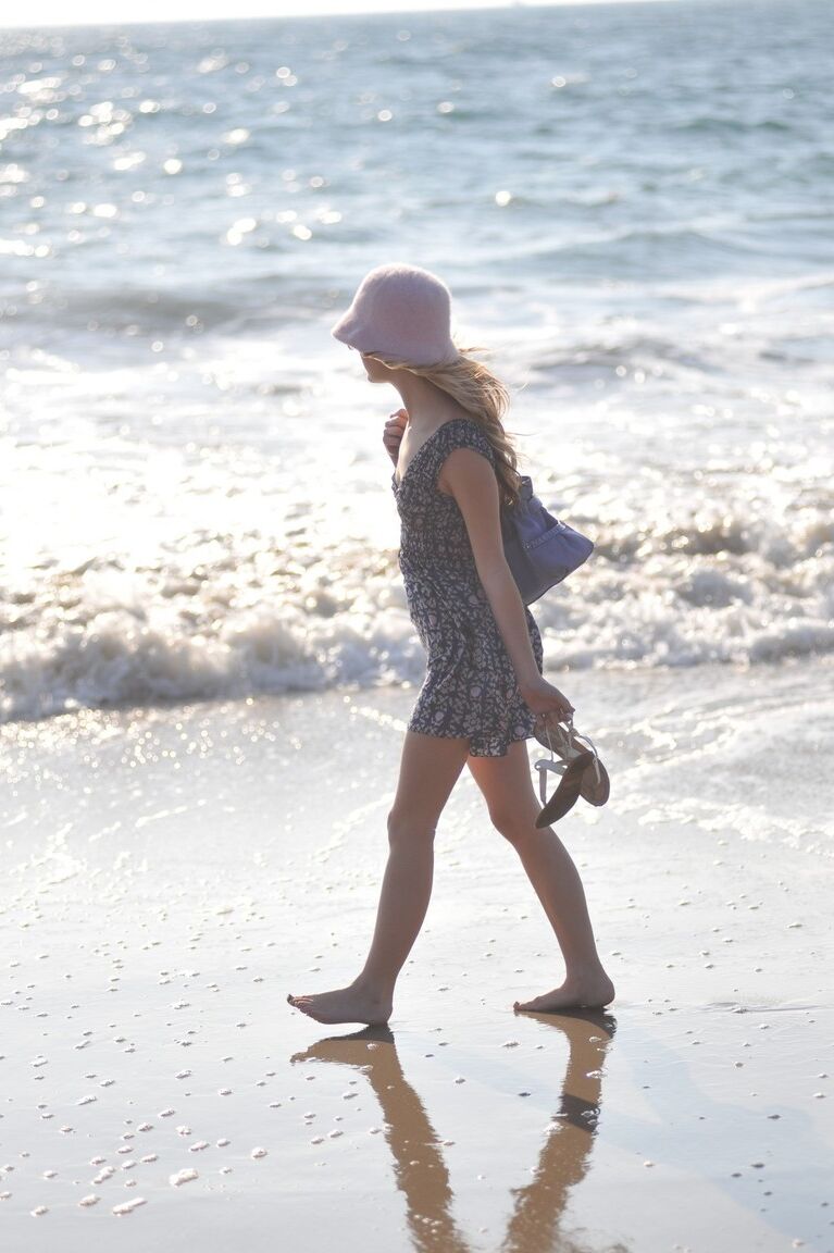 12P Glamour girl Sarah James flashes her upskirt underwear while at the seaside