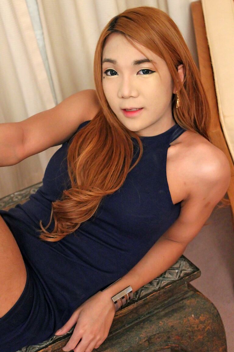 21P Redheaded ladyboy Pinky strips in a solo and shows her tiny curved dick