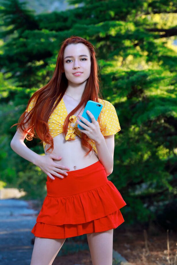 18P Young redhead Sherice gets totally naked after taking selfies on a forest path