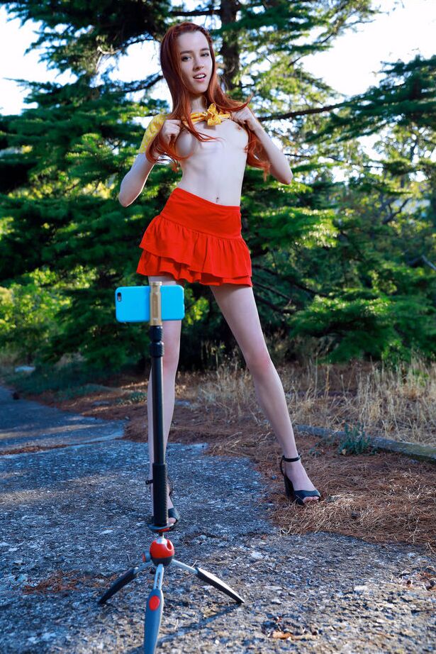 18P Young redhead Sherice gets totally naked after taking selfies on a forest path