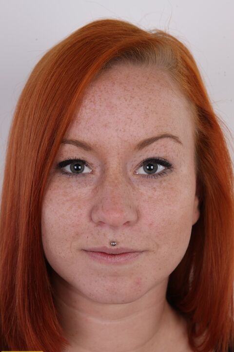 20P Freckled redhead Tereza shows her pierced pussy after getting completely naked