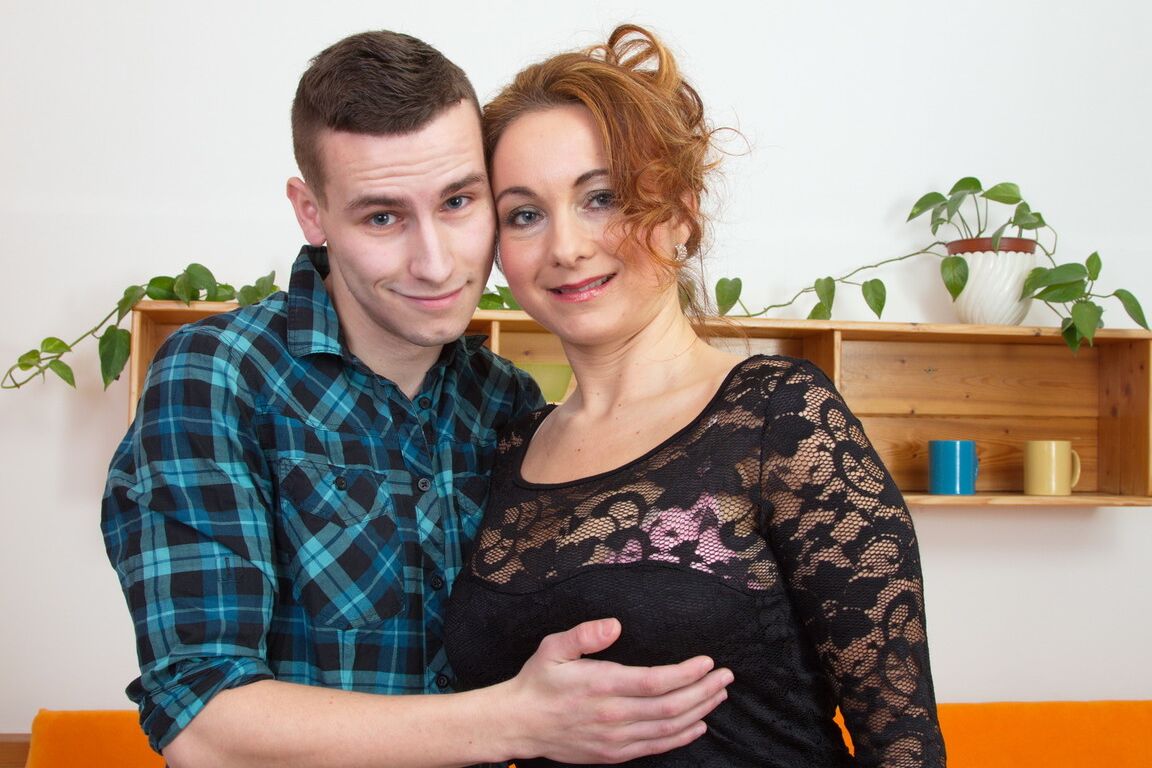 15P Horny older cougar frees great big tits to satisfy her boy toy on the couch