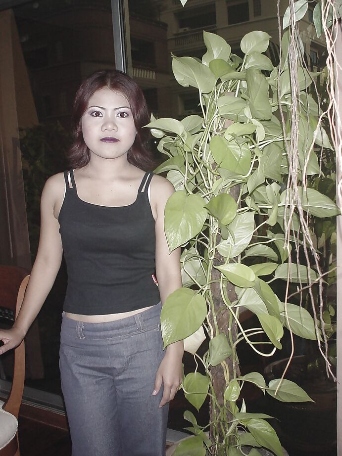 16P Asian milf slut Dee is revealing her big tits while posing in tight jeans