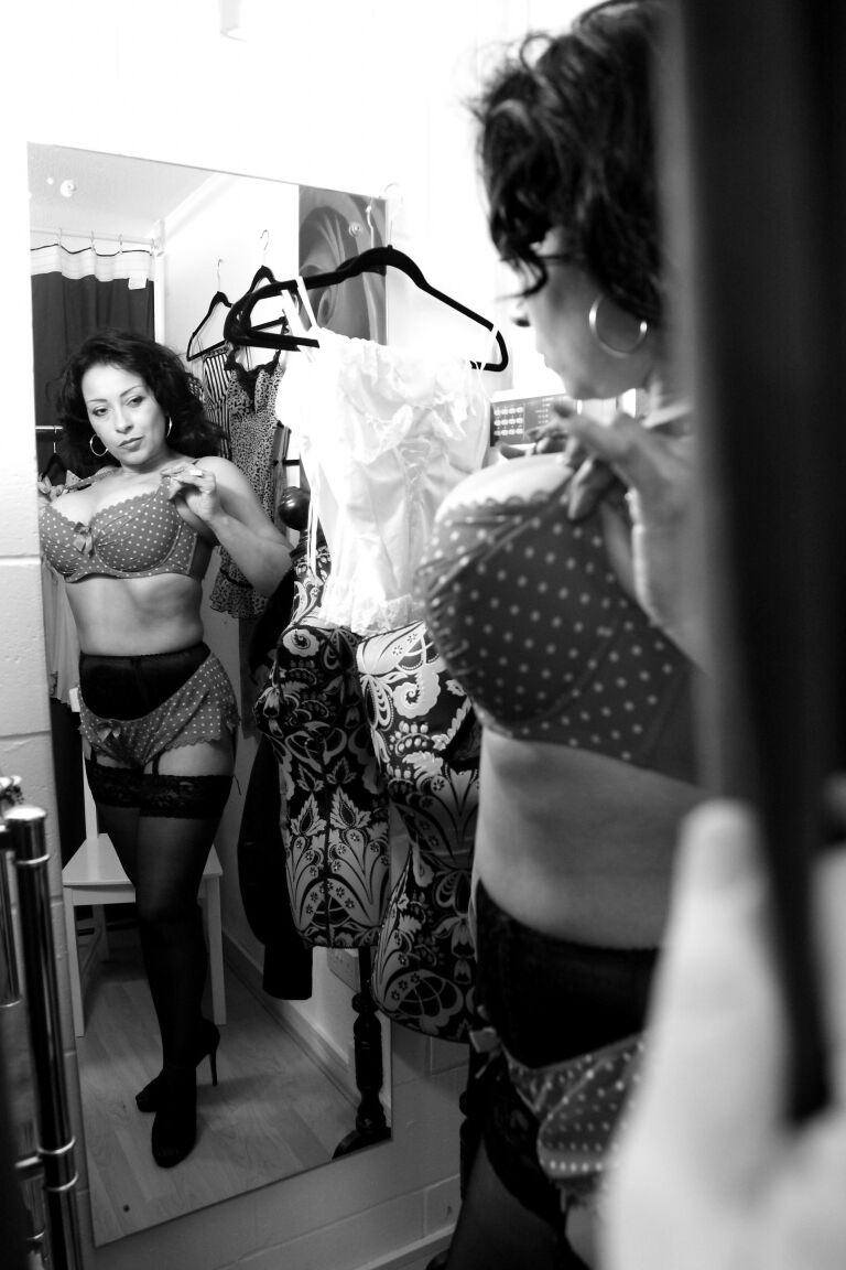 16P Busty older woman Danica Collins models nylons and garters afore a mirror