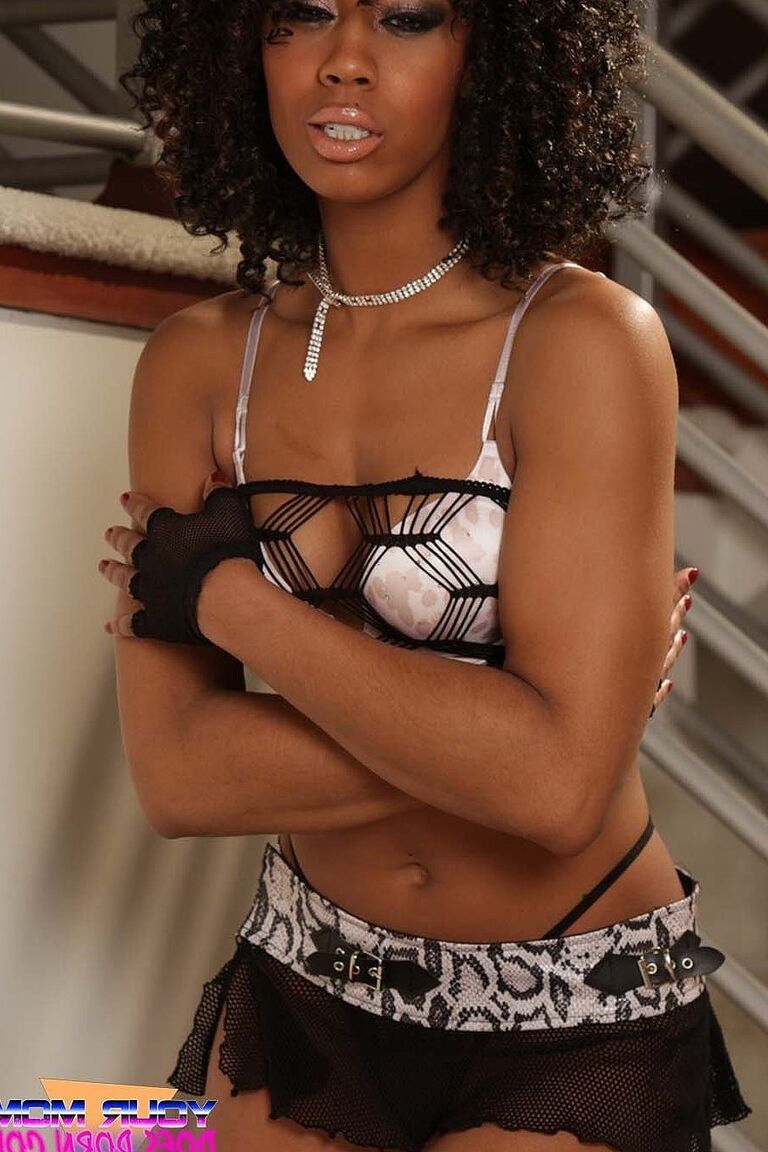21P Curly haired ebony Misty Stone shows her tight booty while posing in a skirt