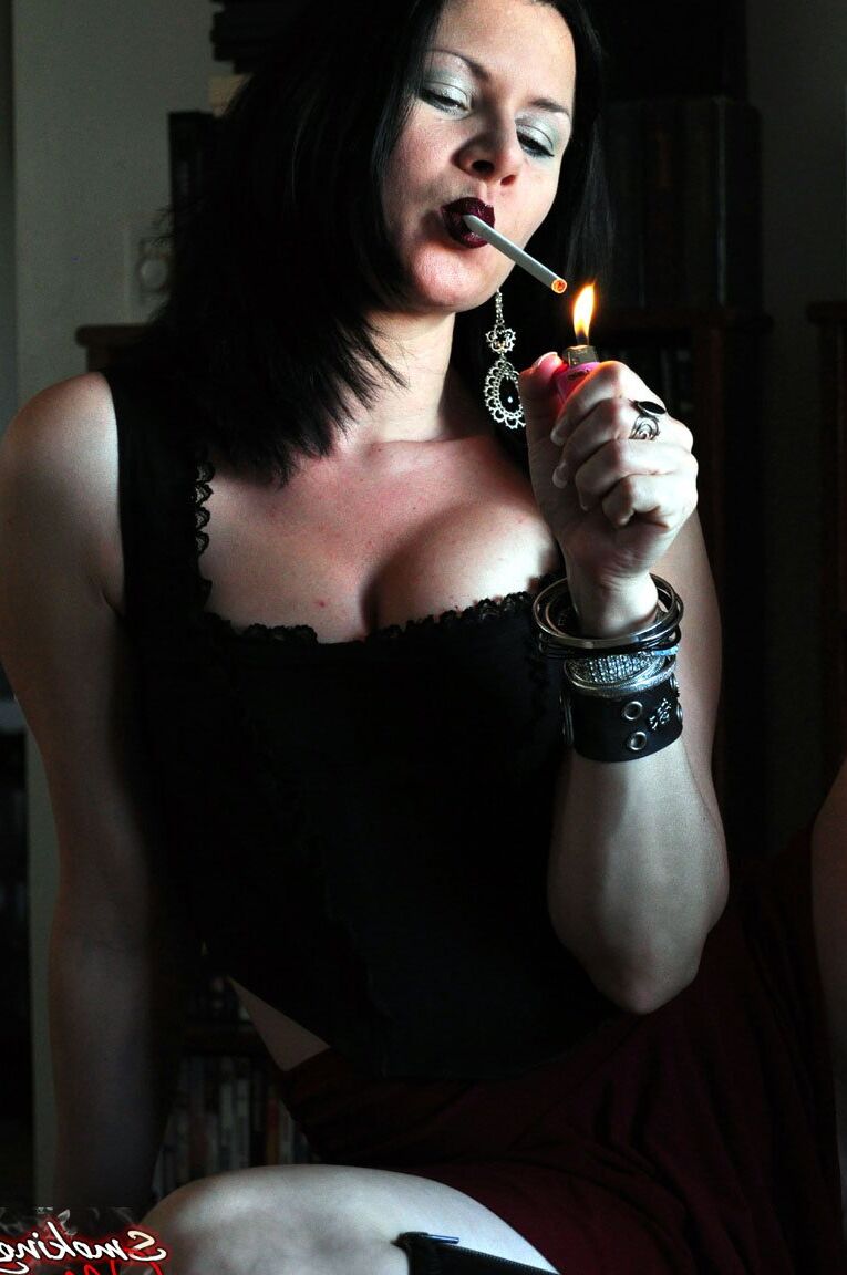 15P Solo model Mina pets her shaved vagina while smoking a cigarette