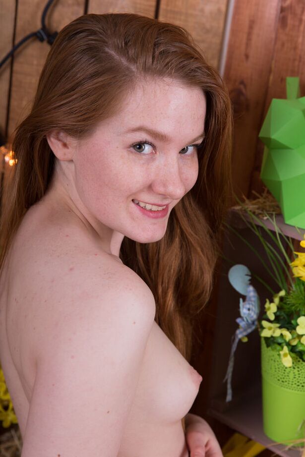 16P Young redhead Anika B performs a bare ass grab upon a bale of straw
