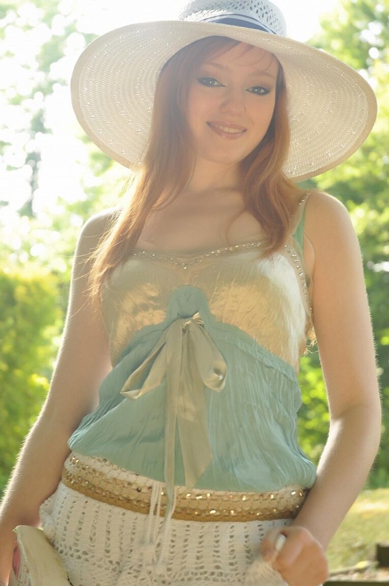 12P Natural redhead Charlie Edwards removes a sunhat while getting naked in a yard