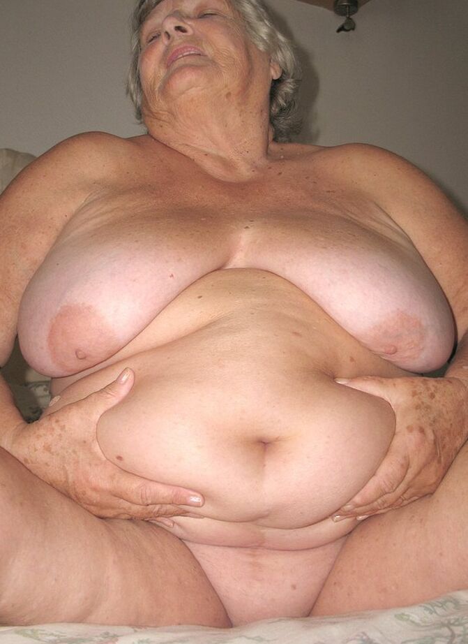 20P Old woman Grandma Libby grabs her fat roll after getting naked on a bed
