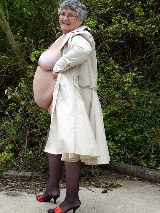 20P Fat nan Grandma Libby flashes by the trees in an overcoat before masturbating